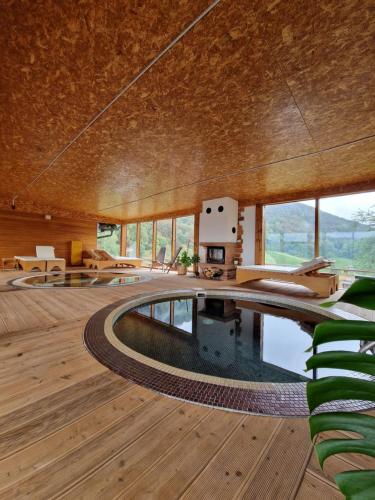 a house with a pool in the middle of a room at Guesthouse Jelenov greben in Podčetrtek