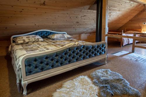 a bedroom with a blue bed in a cabin at ZIDANICA KRŠTINC in Straža