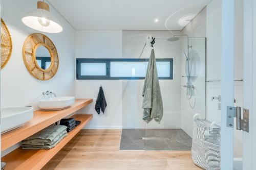 a bathroom with a sink and a shower at Vila Inanda in Ponta do Sol