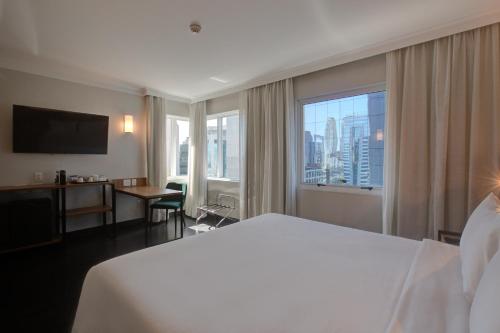 a hotel room with a large bed and a large window at Park Inn by Radisson Berrini in São Paulo