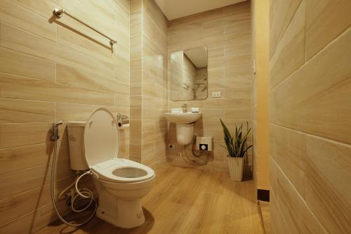 a bathroom with a toilet and a sink at Jai-cob’s Suites in Coron