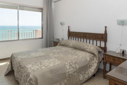 a bedroom with a bed with a view of the ocean at Lider, 12-G in Cullera