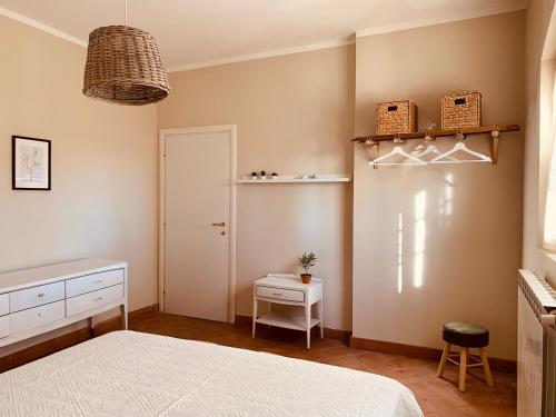 a bedroom with a bed and a door and shelves at La casa nei campi in Badia Pavese