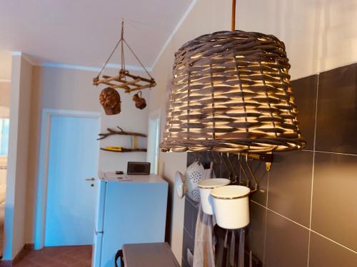 a large chandelier in a kitchen with a refrigerator at La casa nei campi in Badia Pavese