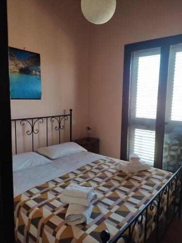 a bedroom with a large bed with towels on it at Casa Mariella in Agrigento
