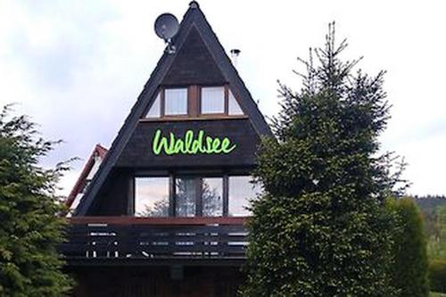 a building with a sign on the top of it at Waldsee in Nagel