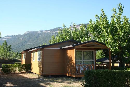 
a small cabin with a view of the mountains at Montsant Park Camping & Bungalow in Ulldemolins

