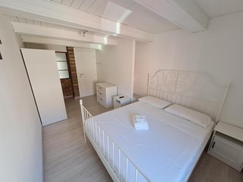 een slaapkamer met een wit bed in een kamer bij Al Castello - Aeroporto delle Marche - Ancona in Falconara Marittima