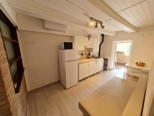 a kitchen with a white refrigerator and a table at Al Castello - Aeroporto delle Marche - Ancona in Falconara Marittima