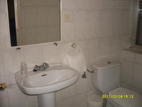 a bathroom with a sink and a toilet at Hostal Residencia Delfin in Astorga