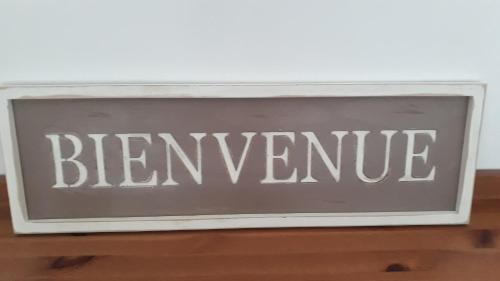 a sign that says bernvenue sitting on a table at KERFERNAND in Berné
