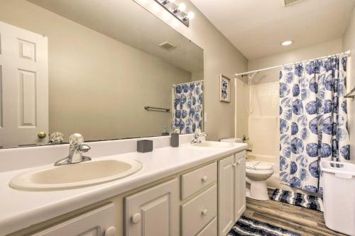 a bathroom with a sink and a toilet at Welcoming Abode with Yard about 1 Mi to Dtwn Apex! in Apex