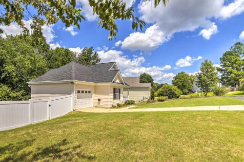 a house with a white fence in a yard at Welcoming Abode with Yard about 1 Mi to Dtwn Apex! in Apex
