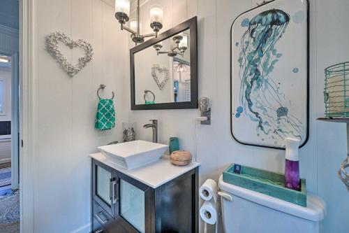 a bathroom with a sink and a toilet and mirrors at Steps to Sand! Topsail Beach Group Getaway! in Surf City