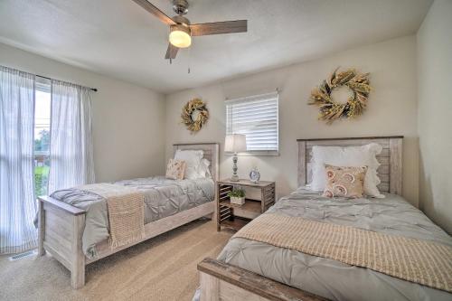a bedroom with two beds and a ceiling fan at Updated Knoxville Home with Media Room and Patio! in Knoxville