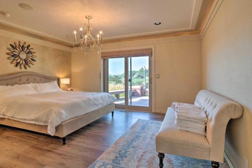 a bedroom with a bed and a chair and a window at Moses Lake Retreat with Salt Water Hot Tub! in Moses Lake