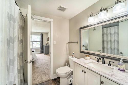 a bathroom with a toilet and a sink and a mirror at 6 Mi to Dtwn Arvada Home with Hot Tub and Yard in Arvada