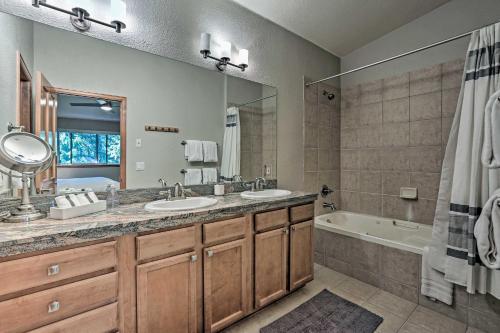 a bathroom with two sinks and a bath tub at Modern Frisco Condo with Deck Walk to Main St! in Frisco