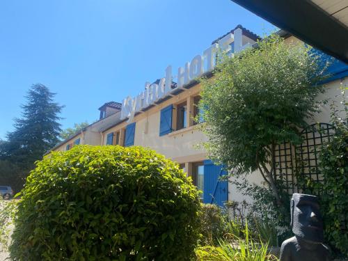 a building with a bush in front of it at Kyriad Beaune in Beaune