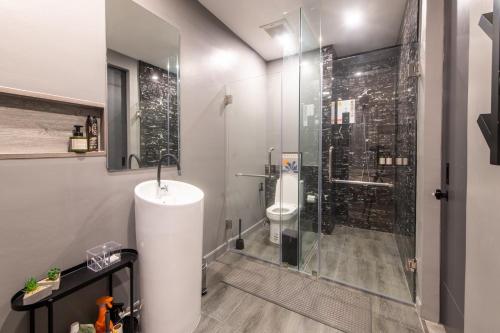 a bathroom with a glass shower and a toilet at Sunny Afternoon Pool Villa ~ Hua-Hin in Hua Hin