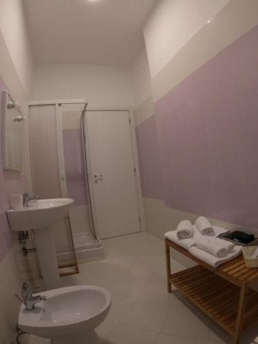 a bathroom with a sink and a toilet and a shower at Ostello Villafranca in Pignola