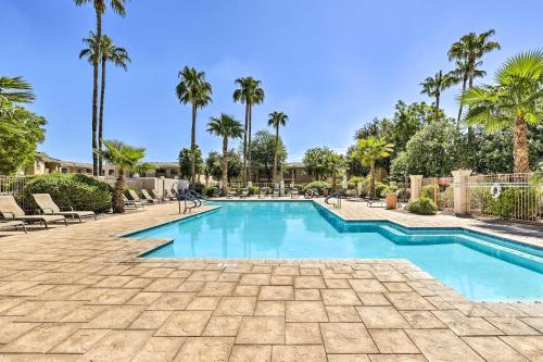 a swimming pool in a resort with palm trees at Communal Pool Sunny First-Floor Condo in Phoenix in Phoenix