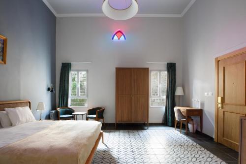 a bedroom with a bed and a table and chairs at Michel House in Nazareth