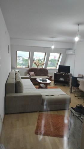 a living room with a couch and a table at Maki & Dare Apartment Ilidza in Sarajevo