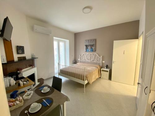 a bedroom with a bed and a table in it at Ostello Villafranca in Pignola