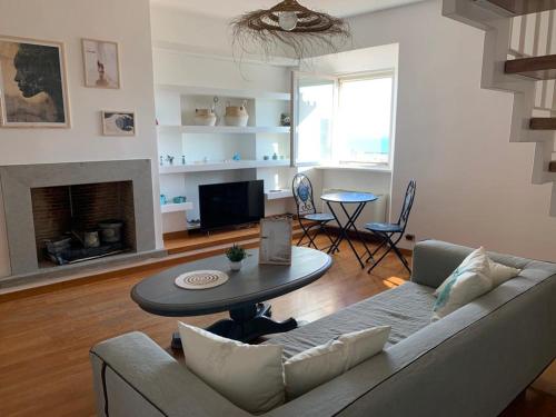 a living room with a couch and a table at Minerva Lodge - Panoramico centro storico Terracina in Terracina