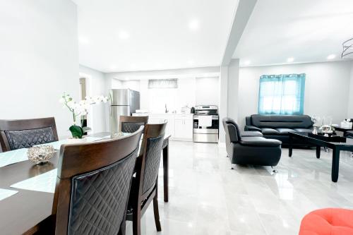 a kitchen and living room with a table and chairs at The Ashland Manor in Niagara Falls