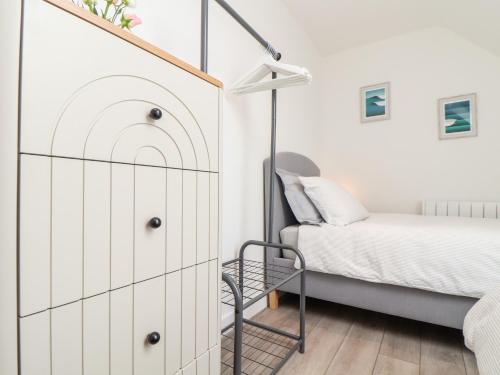 a bedroom with a bed and a dresser at Marazion Attic in Marazion