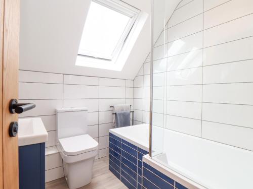 a bathroom with a toilet and a window at Marazion Attic in Marazion