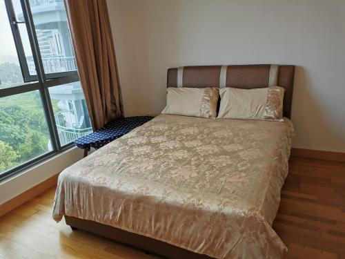 a bed in a room with a large window at Happy Home@Teega Residence Puteri Harbour in Nusajaya