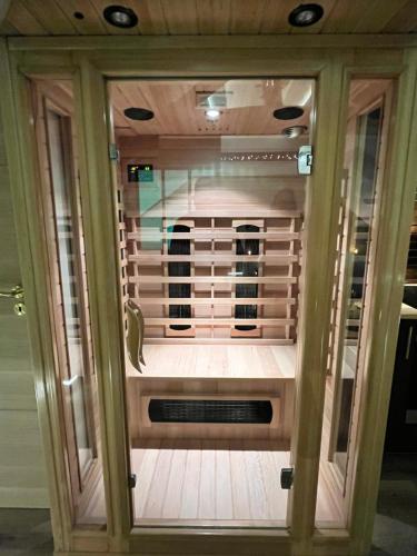 a wooden cabinet with a window in a room at L'Intemporel Suite Spa in Champagne-sur-Oise