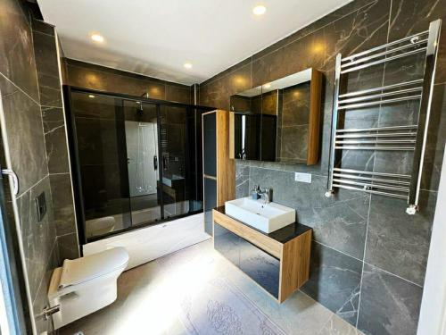 uma casa de banho com um lavatório e um WC em Beachside Villa em Silivri