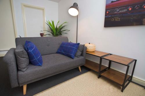 a living room with a couch and a table at 56a Mina Rd in Bristol