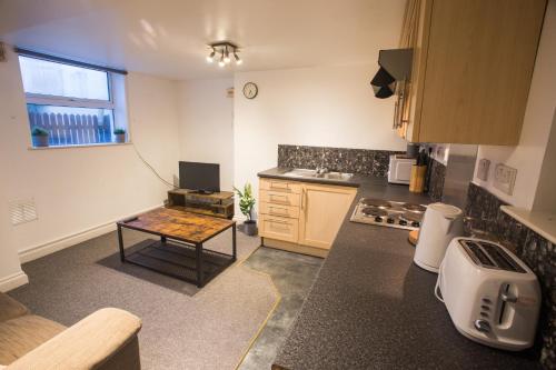 a kitchen with a table in the middle of it at Flat 1, 4 Warden Rd in Bristol