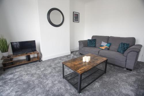 a living room with a couch and a coffee table at 20b Ralph rd in Bristol