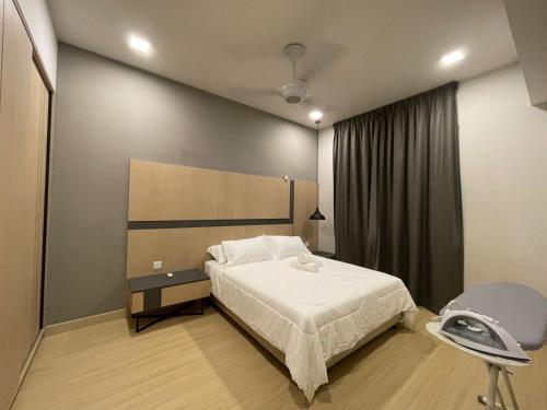 a bedroom with a bed and a chair in it at Kincir Homesuites - Free WiFi & Netflix in Genting Highlands