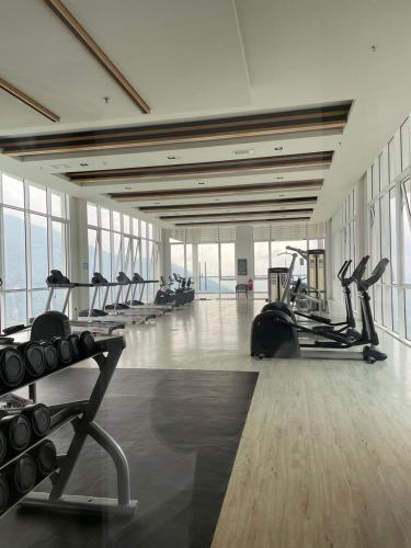 a gym with rows of treadmills and exercise bikes at Kincir Homesuites - Free WiFi & Netflix in Genting Highlands