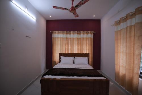 a bedroom with a large bed with a window at God's gift in Devikolam