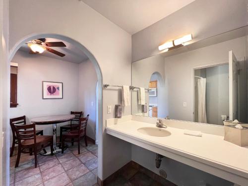 a bathroom with a sink and a table at Casa Del Mar Inn in Santa Barbara