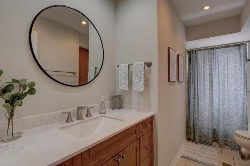 a bathroom with a sink and a mirror at Walk to Vanderbilt Beach From Our Naples Park Home in Naples