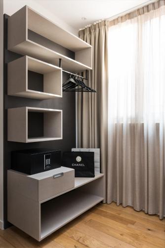 a living room with white shelves and a window at AT FORTY-ONE in Rome