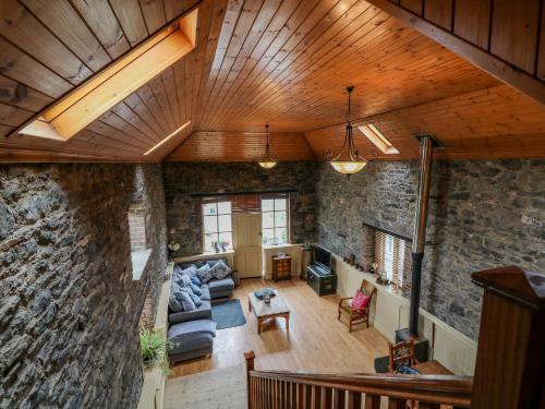 an open living room with a stone wall at Coach House in Portlaoise