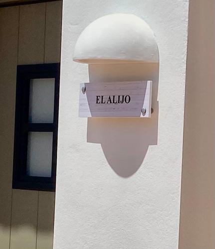 a sign on the side of a building that reads melilo at Apartamento para pareja, Finca Contrabando. Sanlucar del Guadiana in Sanlúcar de Guadiana