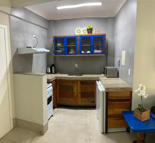 cocina con armarios azules y encimera en Ap à 170m do mar, Praia dos Ingleses, en Florianópolis