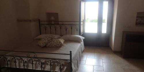 a bedroom with a bed with two pillows on it at Cummersa dell'alba in Locorotondo