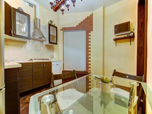 a kitchen with a glass table and chairs in it at Cosy apartment for couple in Šibenik